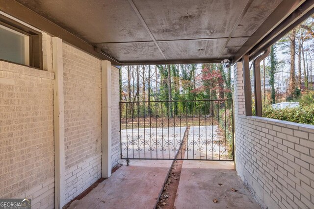 rear view of property with a carport, central air condition unit, and a lawn