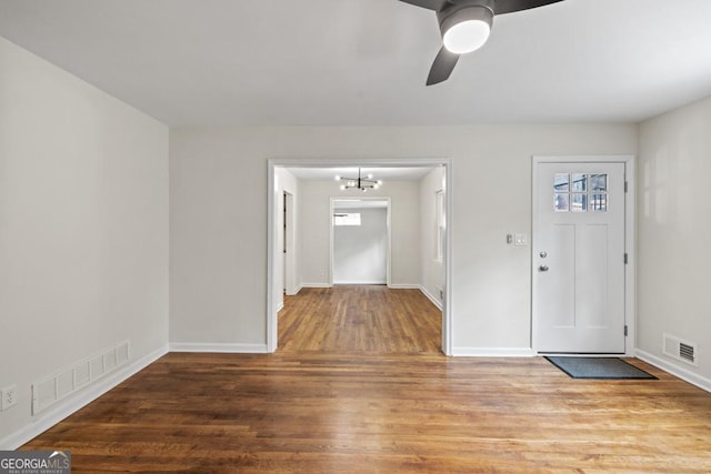 entrance foyer featuring hardwood / wood-style flooring and ceiling fan with notable chandelier