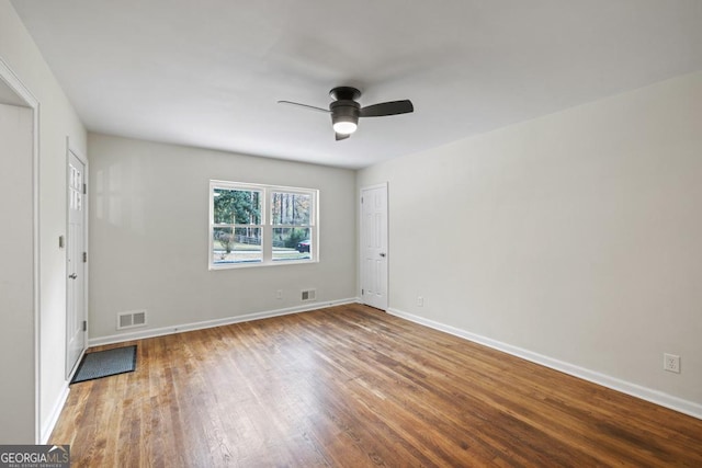 empty room with hardwood / wood-style flooring and ceiling fan