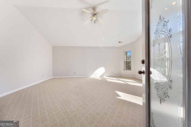 interior space with carpet, vaulted ceiling, and ceiling fan