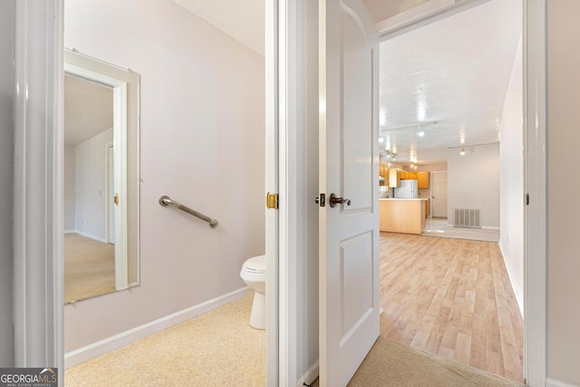 bathroom featuring toilet and hardwood / wood-style flooring