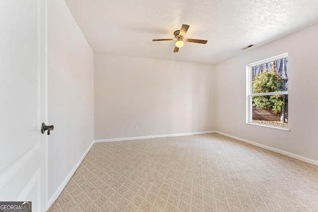 spare room with ceiling fan, carpet floors, and a textured ceiling