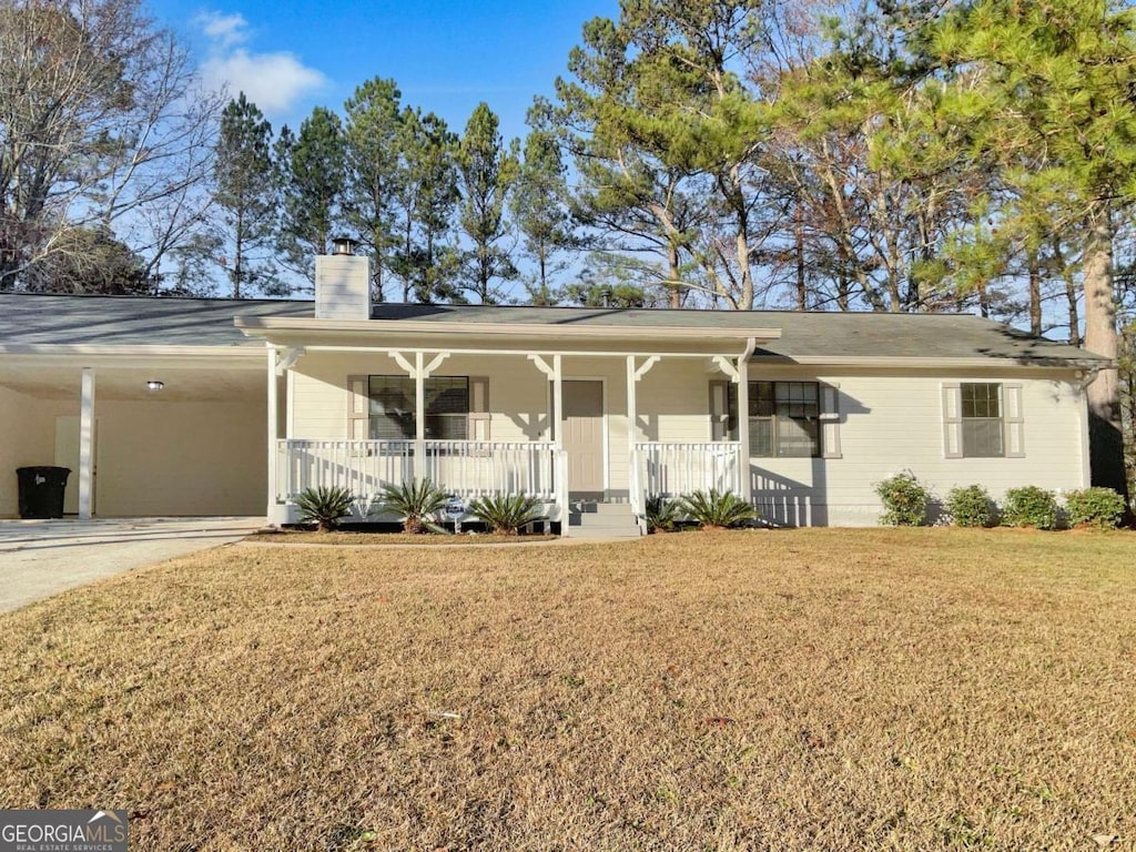 ranch-style house with a front yard, a carport, and covered porch