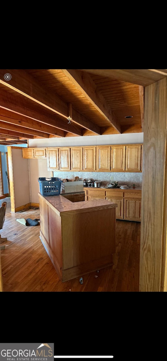 kitchen featuring beamed ceiling, dark wood-type flooring, and wood ceiling