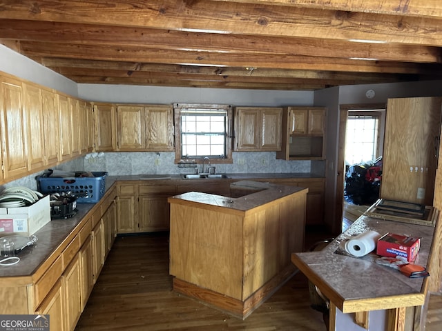 kitchen with beam ceiling, sink, tasteful backsplash, dark hardwood / wood-style flooring, and light brown cabinetry