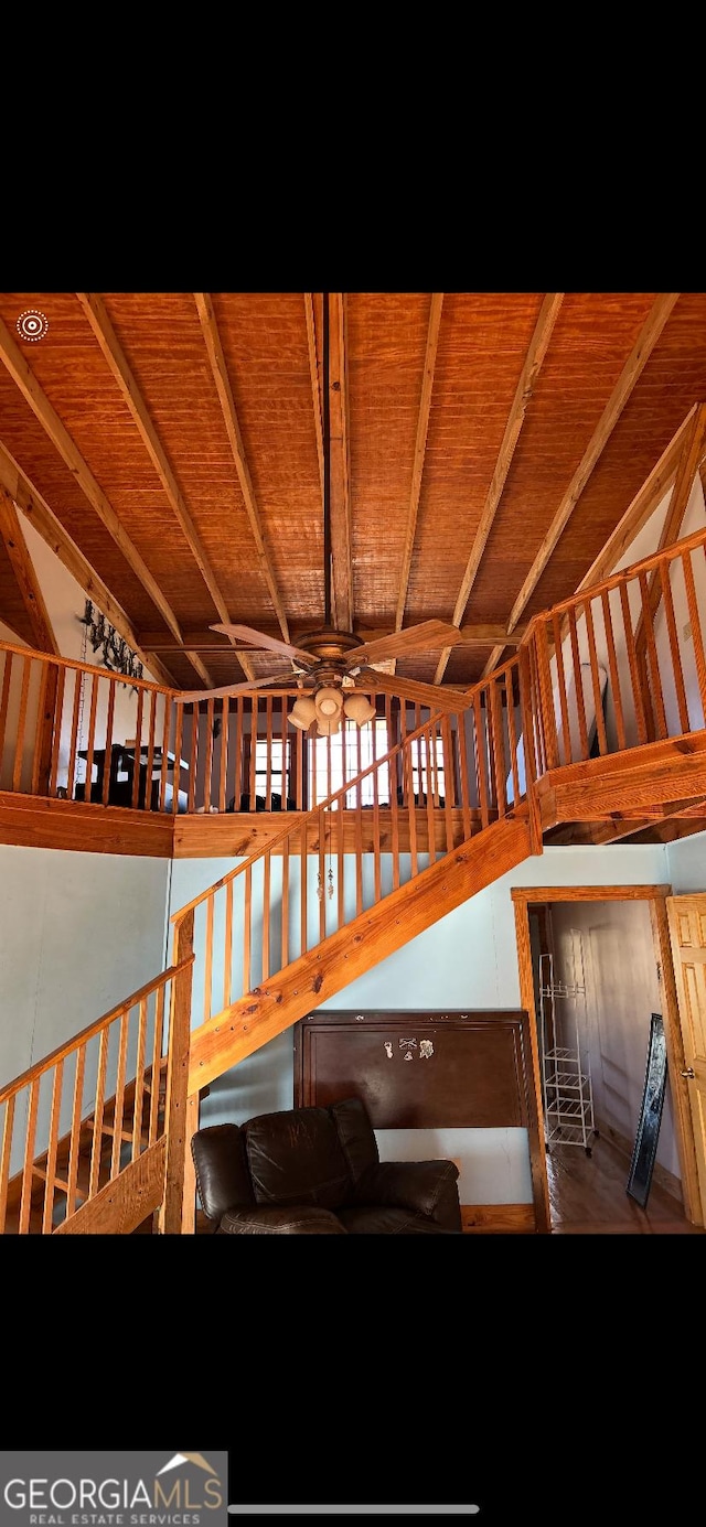 staircase featuring ceiling fan, lofted ceiling, and wood ceiling