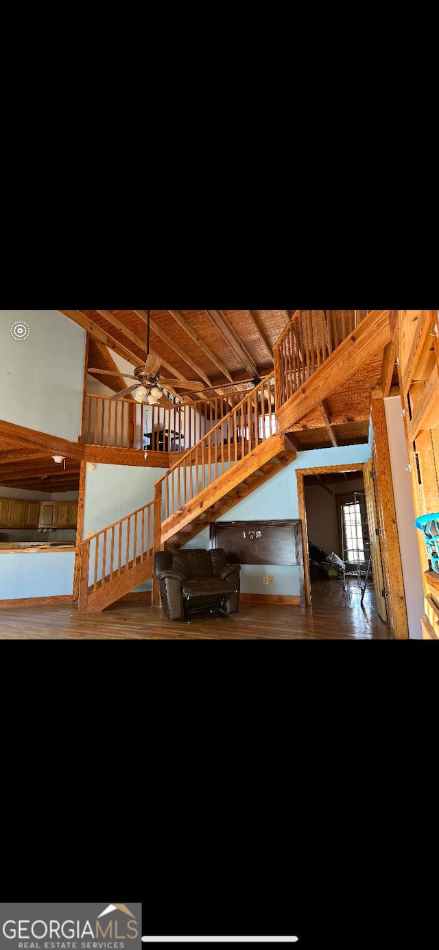 interior space with ceiling fan