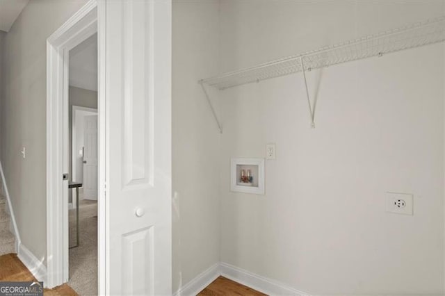 washroom with electric dryer hookup, washer hookup, and wood-type flooring