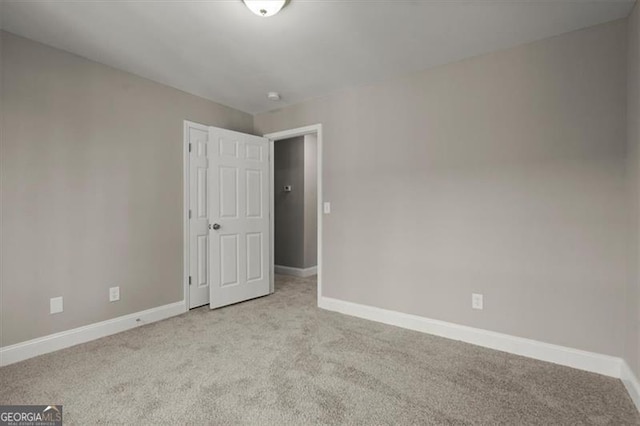 empty room featuring light carpet