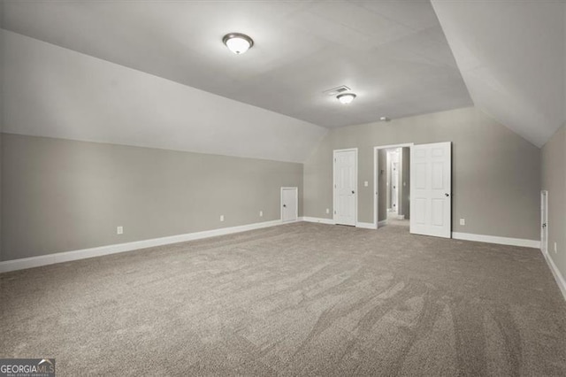 additional living space with carpet and lofted ceiling