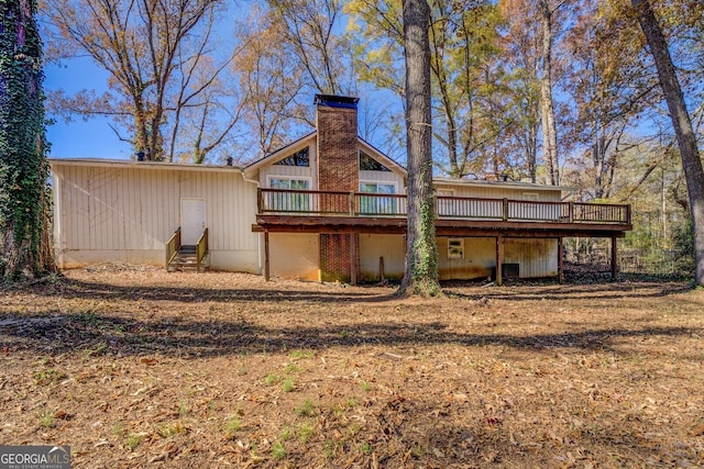 back of house with a deck