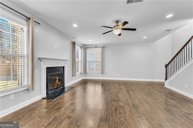 unfurnished living room featuring dark hardwood / wood-style floors and ceiling fan