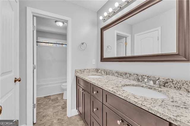 full bathroom with vanity, shower / bath combination, and toilet