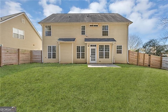 back of house with a yard and a patio