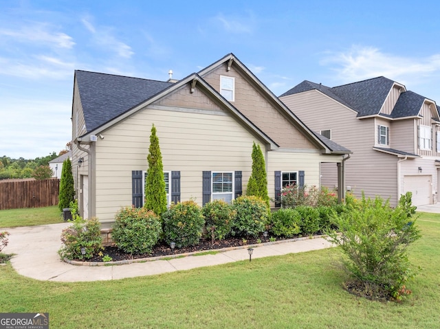 view of front of home featuring a front yard and a garage