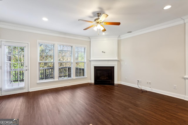 unfurnished living room with dark hardwood / wood-style floors, ceiling fan, ornamental molding, and a fireplace