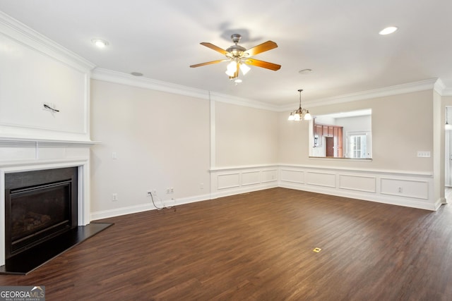 unfurnished living room with ceiling fan with notable chandelier, dark hardwood / wood-style flooring, and ornamental molding