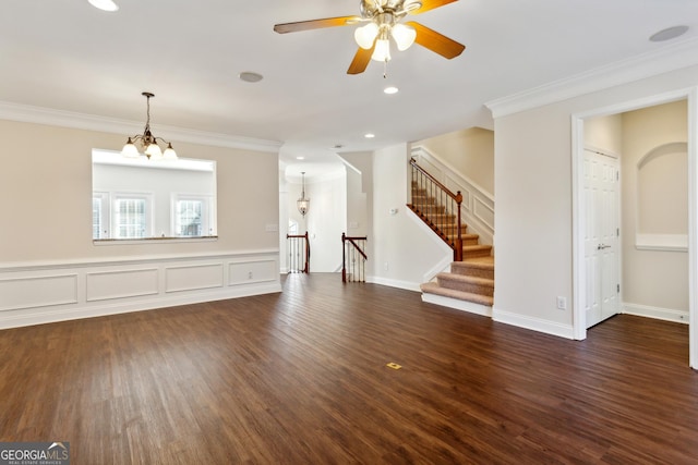 unfurnished living room with ceiling fan with notable chandelier, dark hardwood / wood-style floors, and crown molding