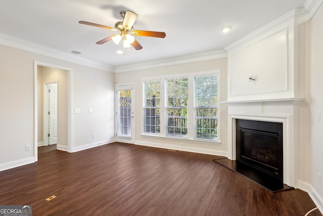 unfurnished living room with ceiling fan, ornamental molding, and dark wood-type flooring