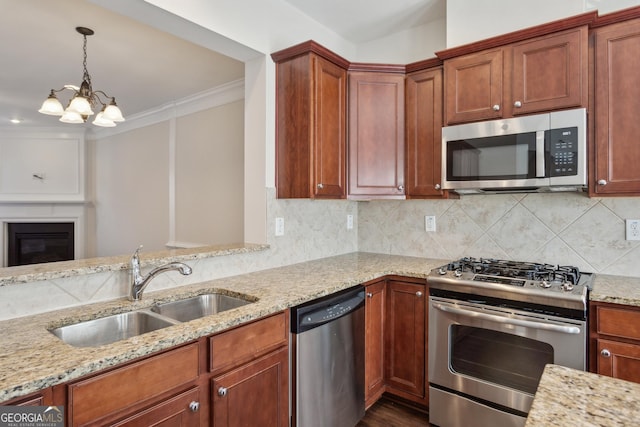 kitchen featuring light stone countertops, a chandelier, sink, and stainless steel appliances