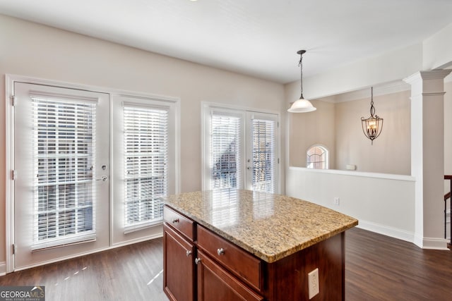 kitchen featuring french doors, dark wood-type flooring, a healthy amount of sunlight, and decorative light fixtures