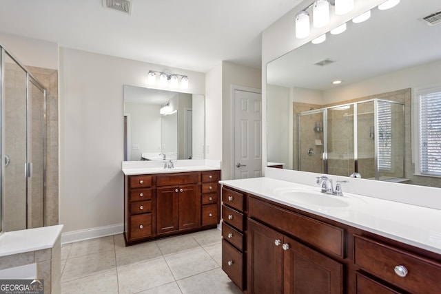 bathroom with vanity, tile patterned floors, and a shower with shower door