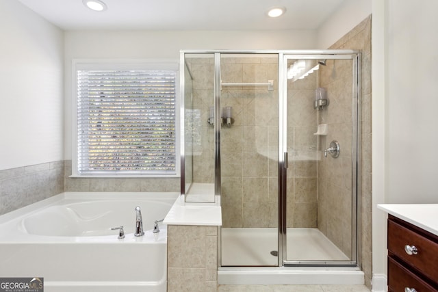 bathroom with vanity and separate shower and tub