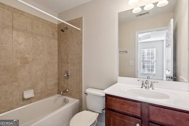 full bathroom with vanity, toilet, and tiled shower / bath