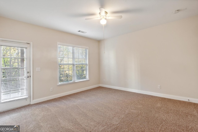 spare room with carpet floors and ceiling fan