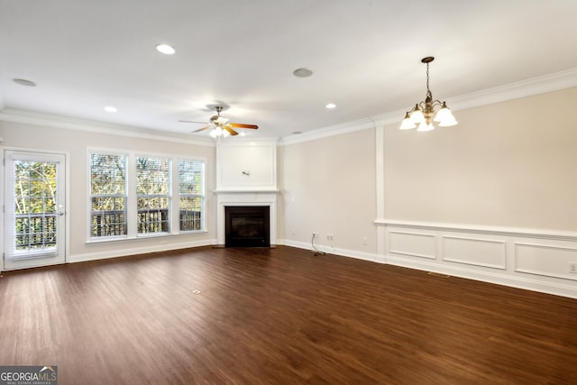 unfurnished living room with dark hardwood / wood-style floors, a large fireplace, and ornamental molding