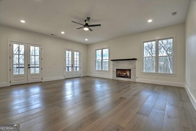 unfurnished living room with dark wood-style floors, recessed lighting, french doors, and ceiling fan