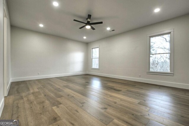 unfurnished room featuring ceiling fan, visible vents, wood finished floors, and recessed lighting