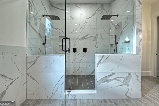 full bathroom with a marble finish shower