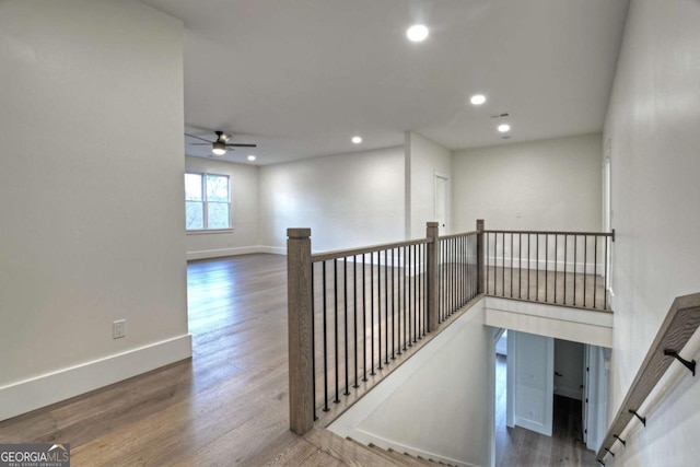 staircase featuring wood finished floors, recessed lighting, a ceiling fan, and baseboards