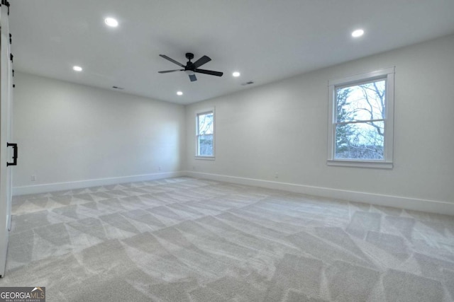 spare room featuring recessed lighting, light colored carpet, and ceiling fan