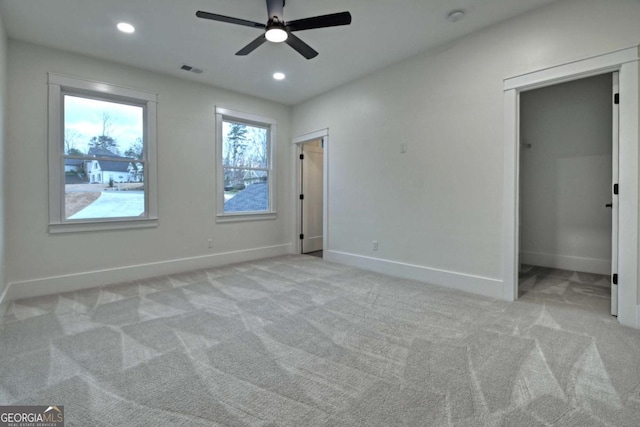 unfurnished bedroom with recessed lighting, visible vents, baseboards, and light colored carpet