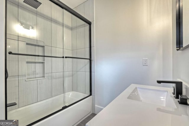 full bathroom featuring tile patterned flooring, enclosed tub / shower combo, and a sink