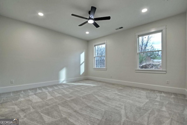 spare room with baseboards, visible vents, and carpet floors