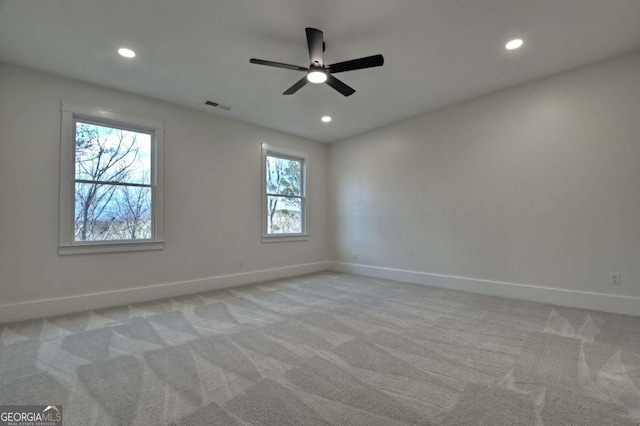 spare room with ceiling fan, recessed lighting, baseboards, and light carpet