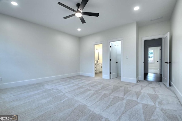 unfurnished bedroom with recessed lighting, baseboards, and light carpet