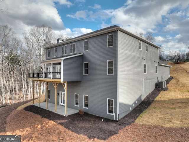 rear view of property featuring cooling unit and a patio