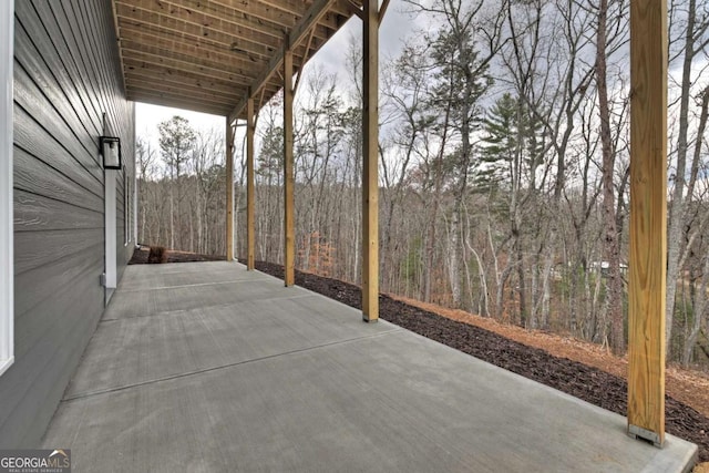 view of patio / terrace featuring a view of trees