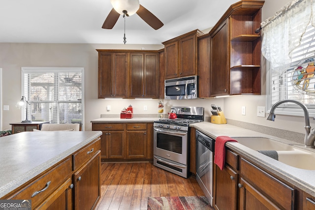 kitchen featuring ceiling fan, light hardwood / wood-style floors, sink, and stainless steel appliances