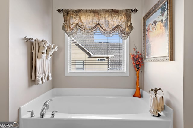 bathroom with lofted ceiling, vanity, ceiling fan, and a tub