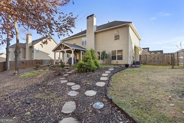 back of house featuring a lawn and cooling unit