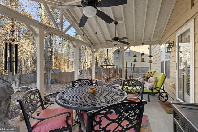 rear view of house with a fire pit and a storage unit