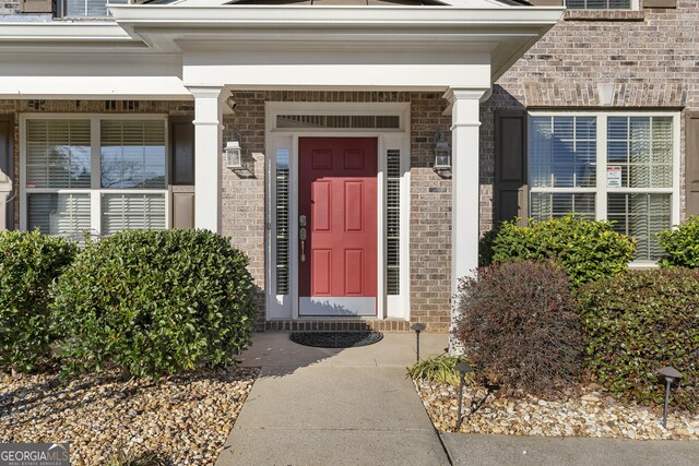 entryway featuring wood-type flooring, plenty of natural light, and ornamental molding