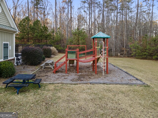 exterior space with a playground and a yard