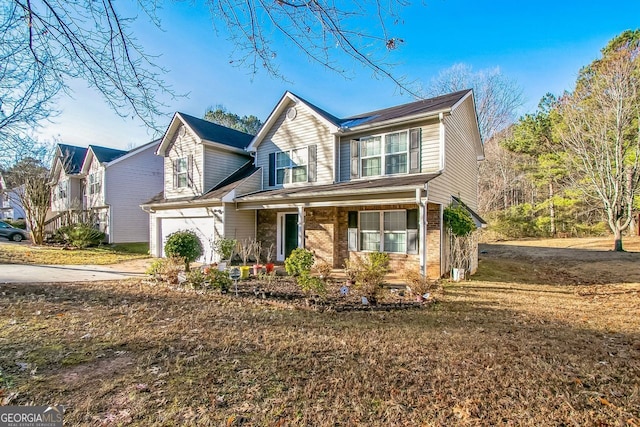 view of front of home featuring a garage and a front yard