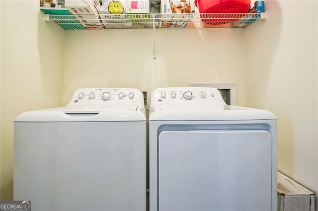 clothes washing area with washing machine and clothes dryer